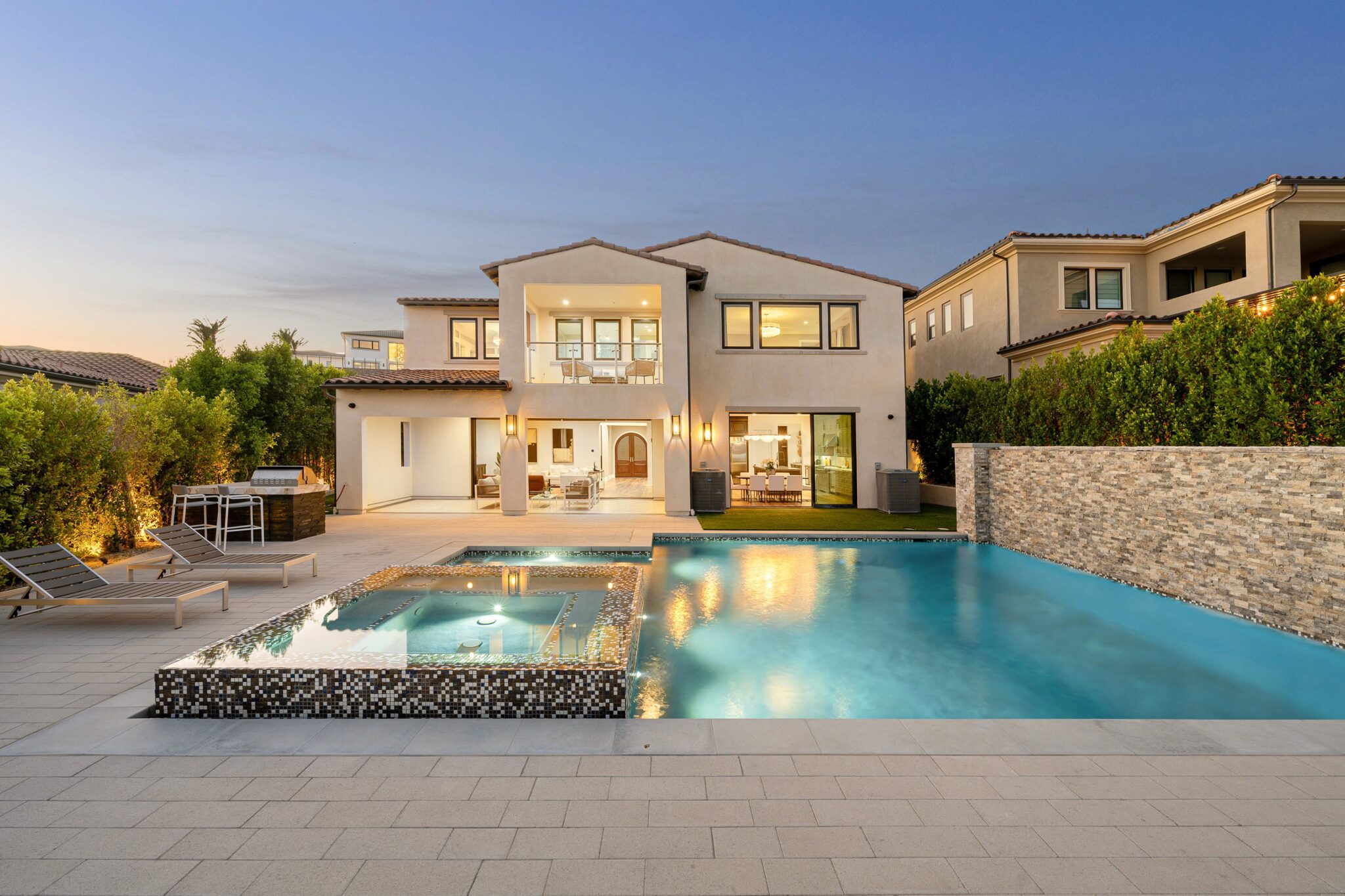 Modern house with pool at sunset.
